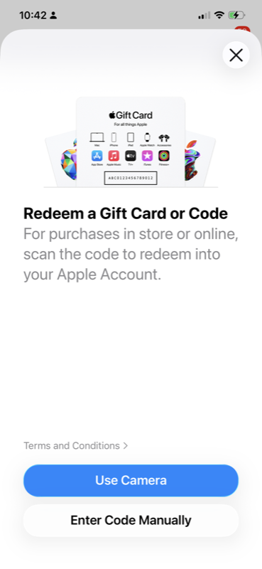 Redeem screen with Use Camera and Enter Code Manually buttons